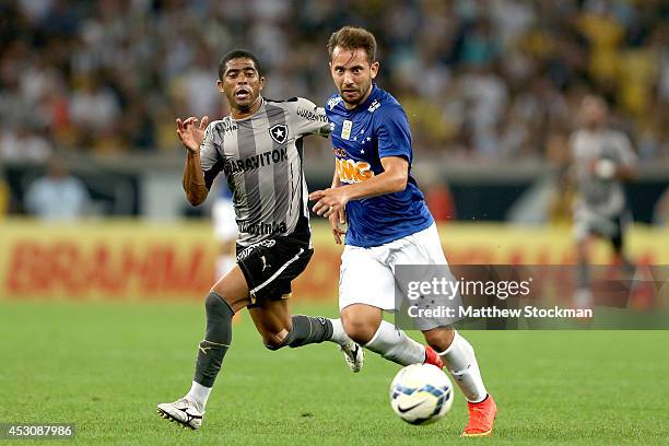 Júnior César#6 of Botafogo chases after Everton Ribeiro of Cruzeiro during a match between Botafogo and Cruzeiro as part of Brasileirao Series A in...