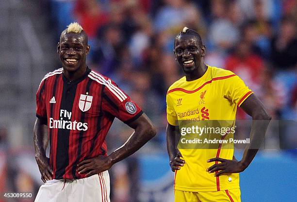 Mamadou Sakho of Liverpool and Mario Balotelli of AC Milan share a joke during the International Champions Cup 2014 match against Liverpool and AC...