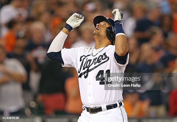 Victor Martinez of the Detroit Tigers celebrates after hitting a three-run home run to center field scoring Ian Kinsler and Miguel Cabrera during the...