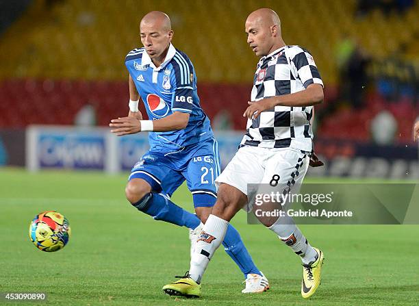 Juan Esteban Ortiz of Millonarios struggles for the ball with Edwin Movil Cabrera of Chico during a match between Millonarios and Chico as part of...