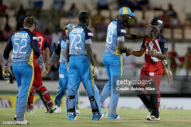 Darren Sammy of St. Lucia Zoucks congratulates Nicholas Pooran of The Red Steel after loosing a match between The Red Steel and St. Lucia Zouks as...