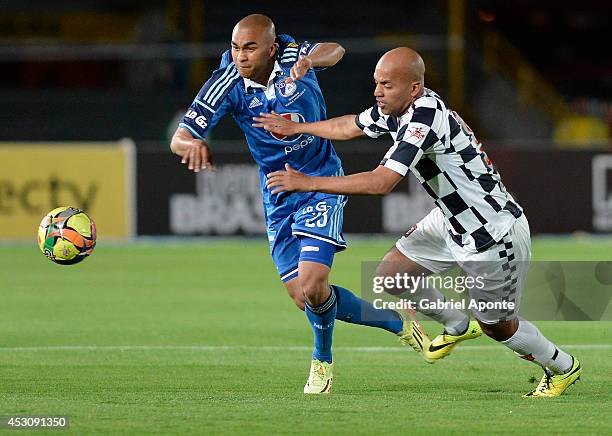 Lewis Ochoa of Millonarios struggles for the ball with Edwin Movil Cabrera of Chico during a match between Millonarios and Chico as part of Liga...
