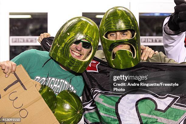 Two fans of the Saskatchewan Roughriders wear watermelons on their heads during a CFL game against the Ottawa Redblacks at TD Place Stadium on August...