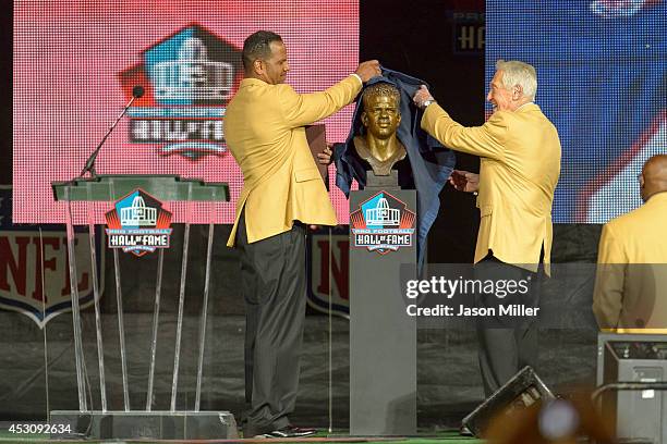 Former NFL wide receiver Andre Reed, left, unveils his bust with his former coach Marv Levy, right, during the NFL Class of 2014 Pro Football Hall of...