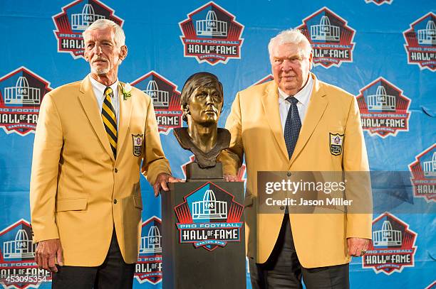 Former NFL punter Ray Guy, left, poses with his bust and former coach John Madden, right, during the NFL Class of 2014 Pro Football Hall of Fame...