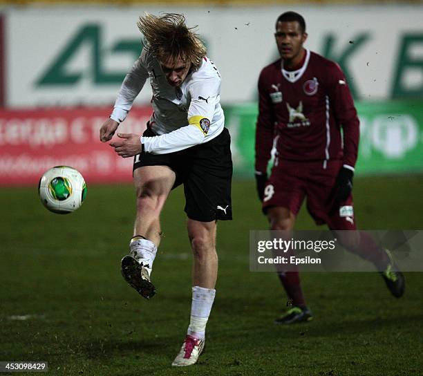 Roman Eremenko of FC Rubin Kazan is challenged by Dmitri Belorukov of FC Amkar Perm during the Russian Football League Championship match between FC...