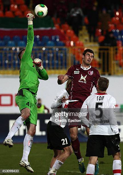 Solomon Kvirkvelia of FC Rubin Kazan is challenged by Sergei Narubin of FC Amkar Perm during the Russian Football League Championship match between...