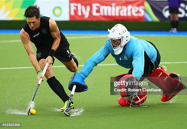 George Pinner of England stretches to stop Simon Child of New Zealand in the shoot out in the bronze medal match between New Zealand and England at...