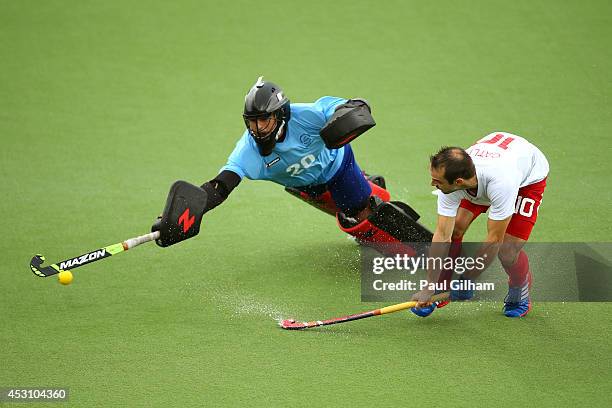 Nick Catlin of England shoots past Devon Manchester of New Zealand to score in the shoot out in the bronze medal match between New Zealand and...