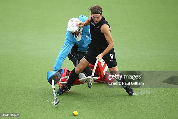 Blair Hilton of New Zealand takes a penalty against Goalkeeper George Pinner of England during a penalty shoot out in the bronze medal match between...