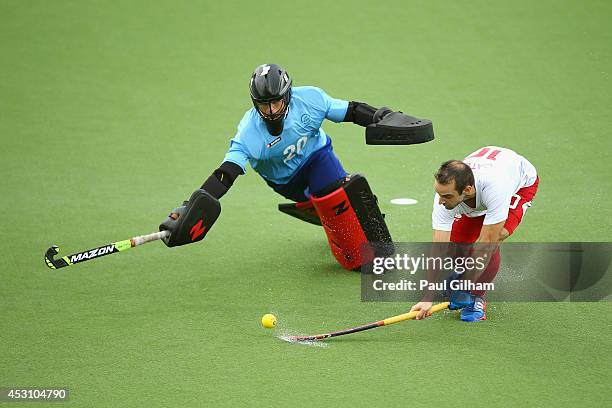 Nick Catlin of England takes a penalty against Goalkeeper Devon Manchester of New Zealnd during a penalty shoot out in the bronze medal match between...