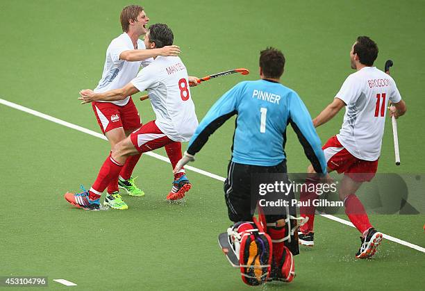 Ashley Jackson of England celebrates with Simon Mantell , George Pinner , and Alastair Brogdon after scoring the winning penalty during a penalty...