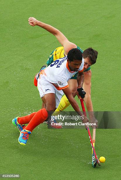 Birendra Lakra of India holds off Matt Gohdes of Australia in the gold medal match between India and Australia at Glasgow National Hockey Centre...