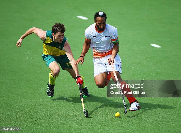 Sardar Singh of India battles with Fergus Kavanagh of Australia in the gold medal match between India and Australia at Glasgow National Hockey Centre...