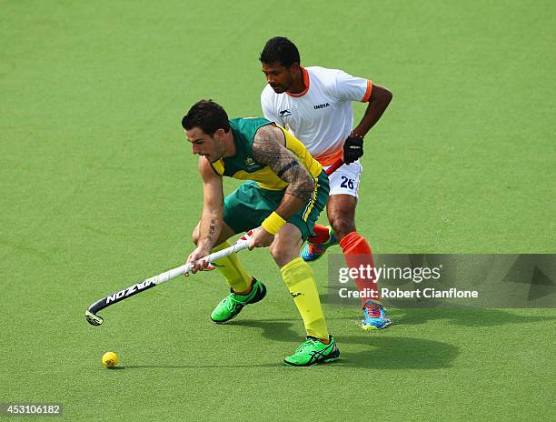 Kieran Govers of Australia holds off Birendra Lakra of India in the gold medal match between India and Australia at Glasgow National Hockey Centre...