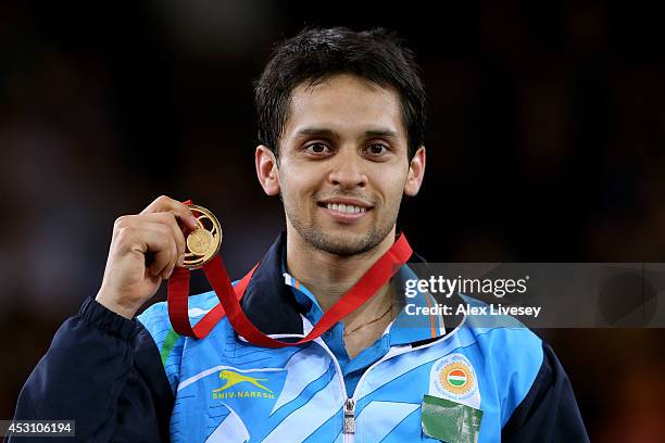 Gold medalist Kashyap Parupalli of India poses in the medal ceremony for the Men's Singles Gold Medal Match at Emirates Arena during day eleven of...