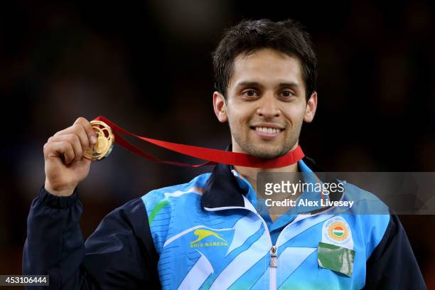 Gold medalist Kashyap Parupalli of India poses in the medal ceremony for the Men's Singles Gold Medal Match at Emirates Arena during day eleven of...