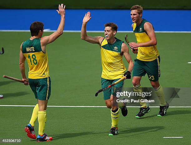 Eddie Ockenden of Australia celebrates with Tristan White and Daniel Beale after scoring the fourth goal for Australia in the Men's Gold Medal Match...