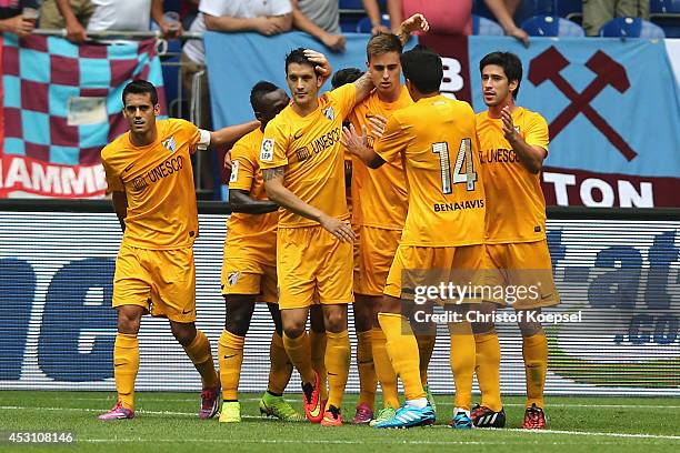 Ezequiel Rescaldani of Malaga celebrates the first goal with his team mates during the match between FC Malaga and West Ham United as part of the...