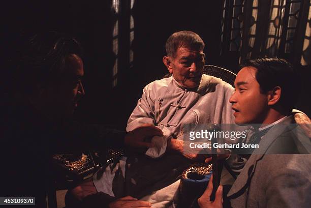 Director Chen Kaige with Hong Kong actor Leslie Cheung Kwok Wing and Chinese actor Xie Tian during the filming of 'Temptress Moon' in Shanghai Film...