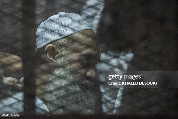 Egyptian radical Islamist Mohammed al-Zawahiri, the brother of Al-Qaeda chief Ayman al-Zawahiri, sits in the defendants cage during his trial with 68...