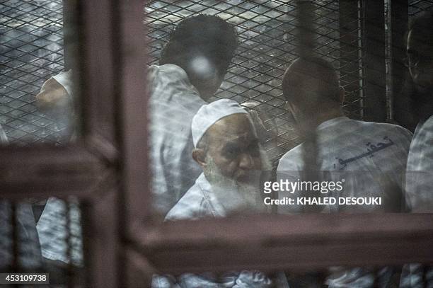 Egyptian radical Islamist Mohammed al-Zawahiri, the brother of Al-Qaeda chief Ayman al-Zawahiri, sits in the defendants cage during his trial with 68...