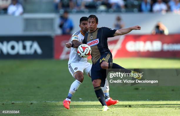 Danny Cruz of Philadelphia Union looks to play the ball from A.J. DeLaGarza of Los Angeles Galaxy during the MLS match at StubHub Center on May 25,...