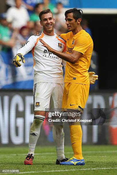 Roque Santa Cruz of Malaga embraces Adrian of West Ham United after winning 2-0 the match between FC Malaga and West Ham United as part of the...