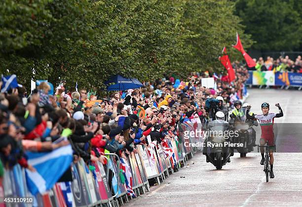 Geraint Thomas of Wales celebrates as he crosses the finish line during the Men's Cycling Road Race during day eleven of the Glasgow 2014...