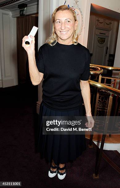 Miuccia Prada, winner of the International Designer of the Year, poses at the British Fashion Awards 2013 at London Coliseum on December 2, 2013 in...