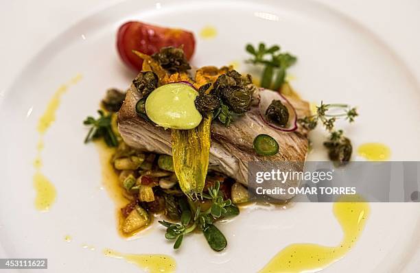 Dorado fish prepared with pumpkin flower, radish and capers, prepared and served by Alejandro Ruiz, chef of the "Casa Oaxaca" restaurant, on July 29,...