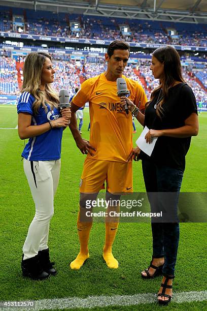 Moderator Vanessa Huppenkothen of Sport 1 television channel and field reporter Laura Wontorra of Sport 1 television interview Roque Santa Cruz of...