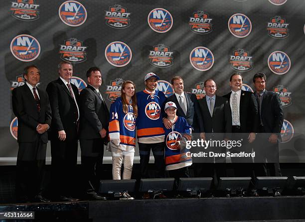 Josh Ho-Sang poses with team personnel after being selected 28th overall by the New York Islanders during the 2014 NHL Entry Draft at Wells Fargo...