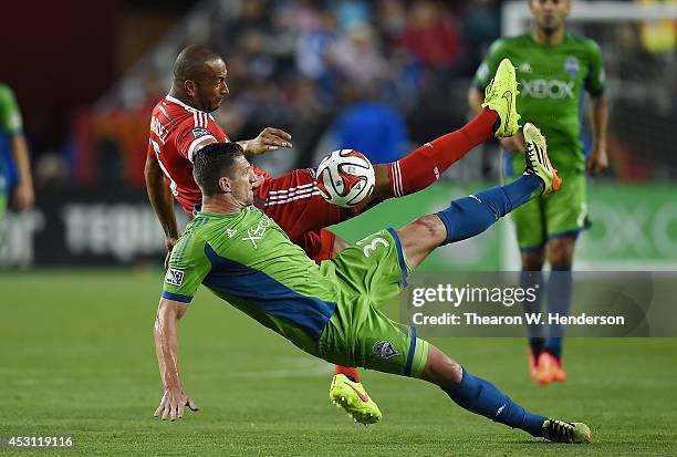 Victor Bernardez of the San Jose Earthquakes battle for the ball with Kenny Cooper of the Seattle Sounder FC during the second half of an MLS Soccer...