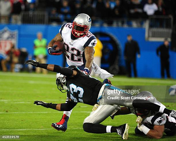 Stevan Ridley of the New England Patriots carries the ball against Melvin White of the Carolina Panthers at Bank of America Stadium on November 18,...