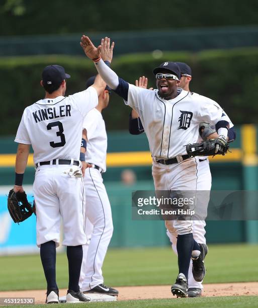 Rajai Davis and Ian Kinsler of the Detroit Tigers celebrate a win over the Colorado Rockies at Comerica Park on August 3, 2014 in Detroit, Michigan....