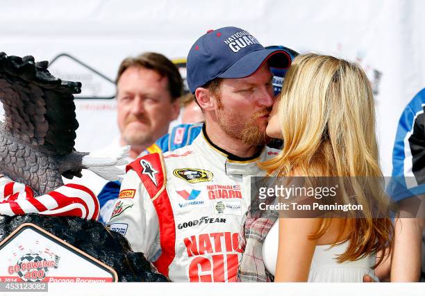 Dale Earnhardt Jr., driver of the Michael Baker International Chevrolet, celebrates in Victory Lane with Amy Reimann after winning the NASCAR Sprint...