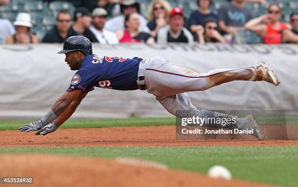 Danny Santana of the Minnesota Twins dives into third base for a run-scoring triple in the 8th inning against the Chicago White Sox at U.S. Cellular...
