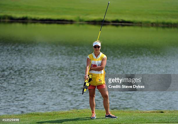 Christina Langer, daughter and caddie of Bernhard Langer of Germany, waits for her father to putt on the 17th hole during the final round of the 3M...