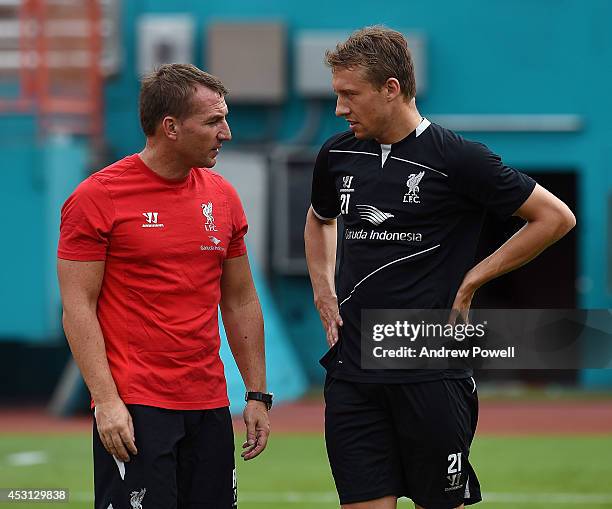 Brendan Rodgers, manager of Liverpool, talks with Lucas Leiva during an open training session at Sunlife Stadium on August 3, 2014 in Miami, Florida.