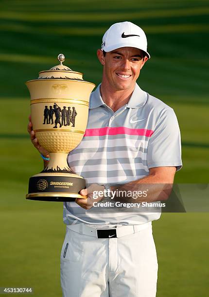 Rory McIlroy of Northern Ireland holds the Gary Player Cup trophy after winning the World Golf Championships-Bridgestone Invitational with a score of...