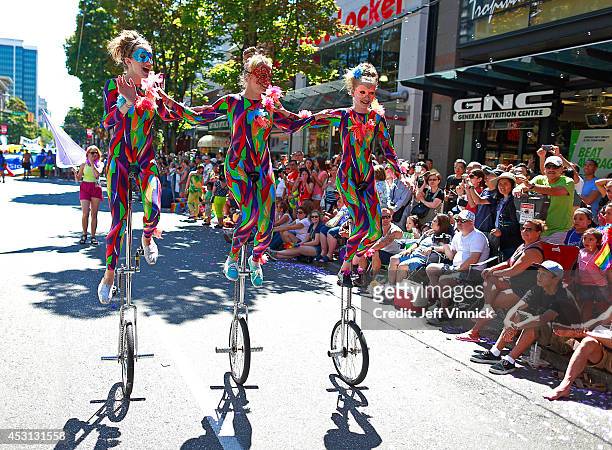 Three women ride unicycles during the Vancouver Pride Parade August 3, 2014 in Vancouver, British Columbia, Canada. The annual event draws more than...