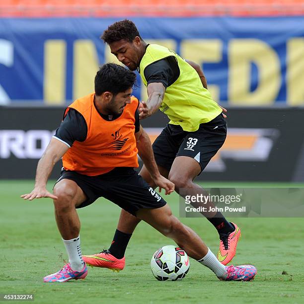 Emre Cana and Jordon Ibe of Liverpool in action during an open training session at Sunlife Stadium on August 3, 2014 in Miami, Florida.