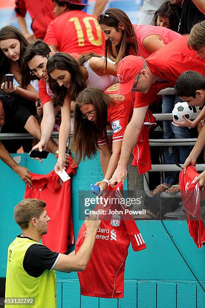 Steven Gerrard of Liverpool signs autographs after an open training session at Sunlife Stadium on August 3, 2014 in Miami, Florida.