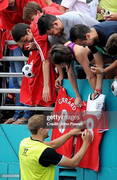 Steven Gerrard of Liverpool signs autographs after an open training session at Sunlife Stadium on August 3, 2014 in Miami, Florida.