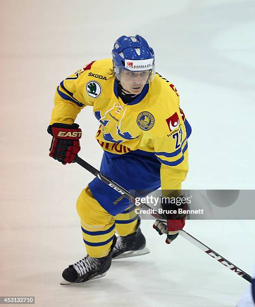 Anton Karlsson 327 of Team Sweden skates against USA White during the 2014 USA Hockey Junior Evaluation Camp at the Lake Placid Olympic Center on...