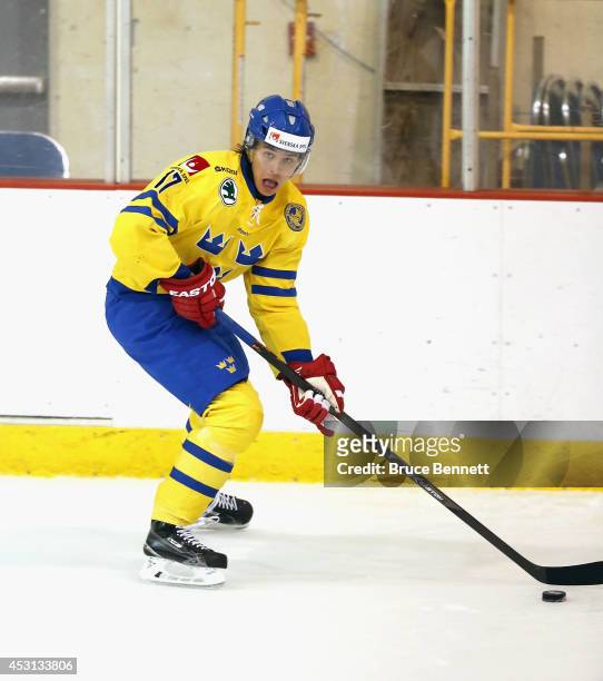 Adrian Kempe of Team Sweden skates against USA White during the 2014 USA Hockey Junior Evaluation Camp at the Lake Placid Olympic Center on August 3,...