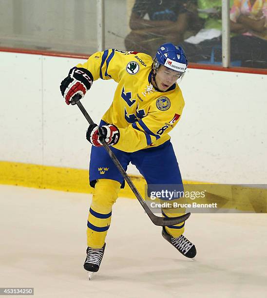 Anton Cederholm of Team Sweden skates against USA White during the 2014 USA Hockey Junior Evaluation Camp at the Lake Placid Olympic Center on August...