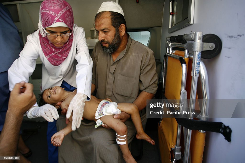 A wounded Palestinian child arrives at the hospital a after...