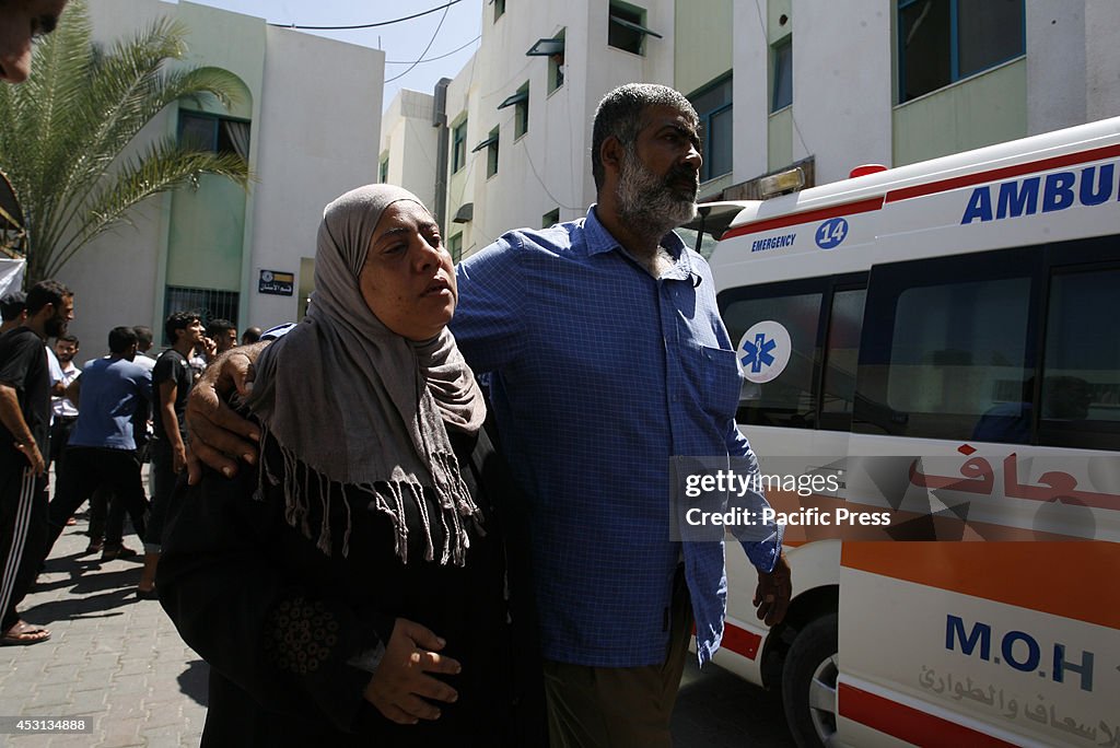 Relatives mourn during the funeral of at least 9 members of...